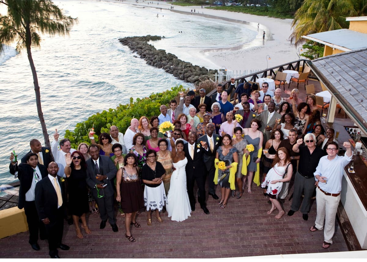 Newlyweds celebrating with family and friends at an oceanfront reception