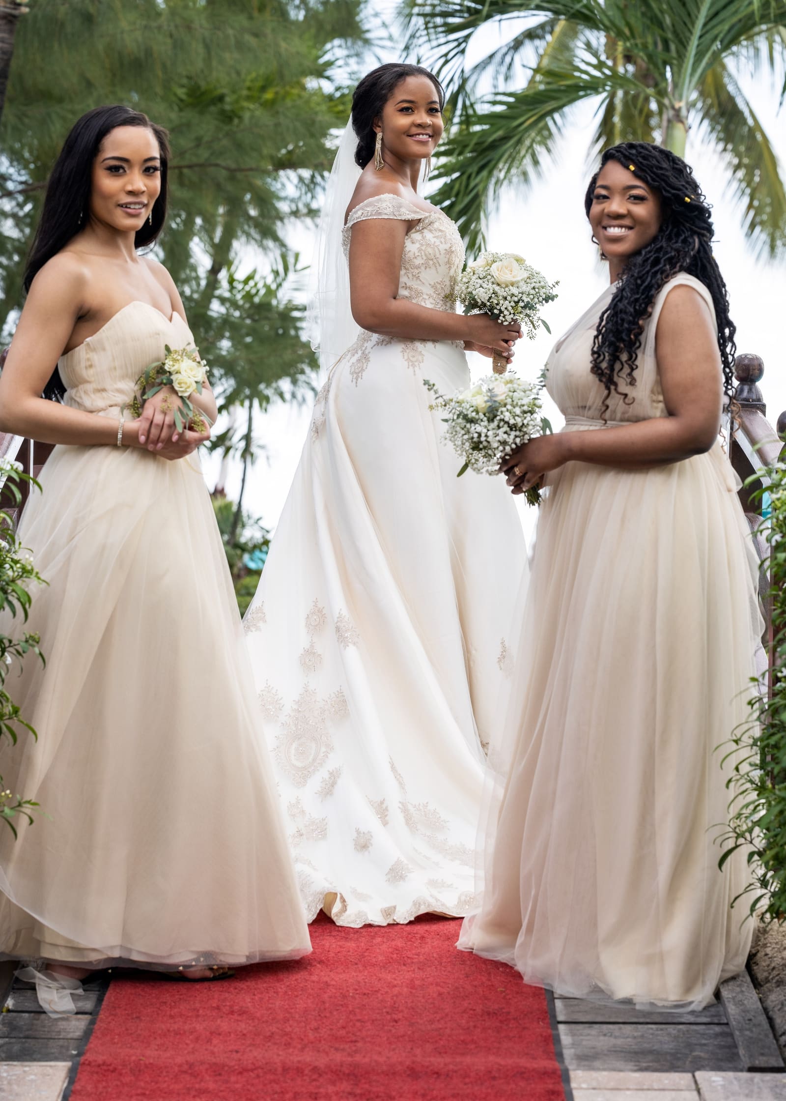 Bride with her two bridesmaids on a red carpet, Barbados