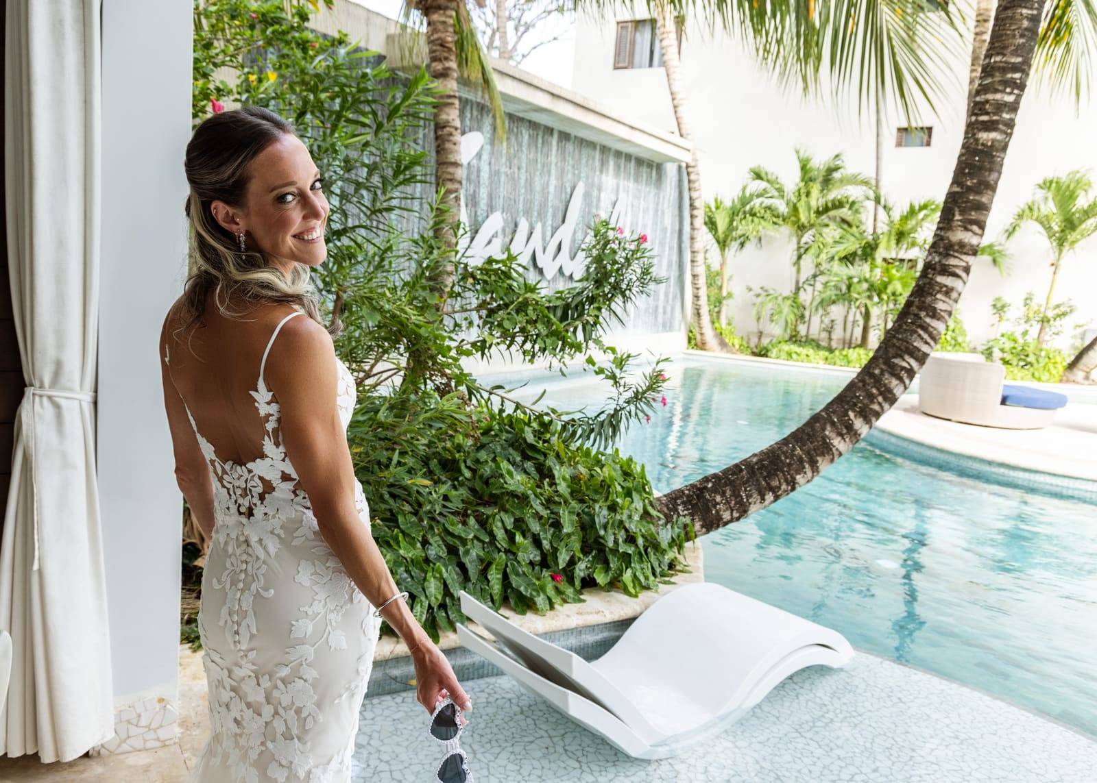 Bride looking back beside a pool, Barbados