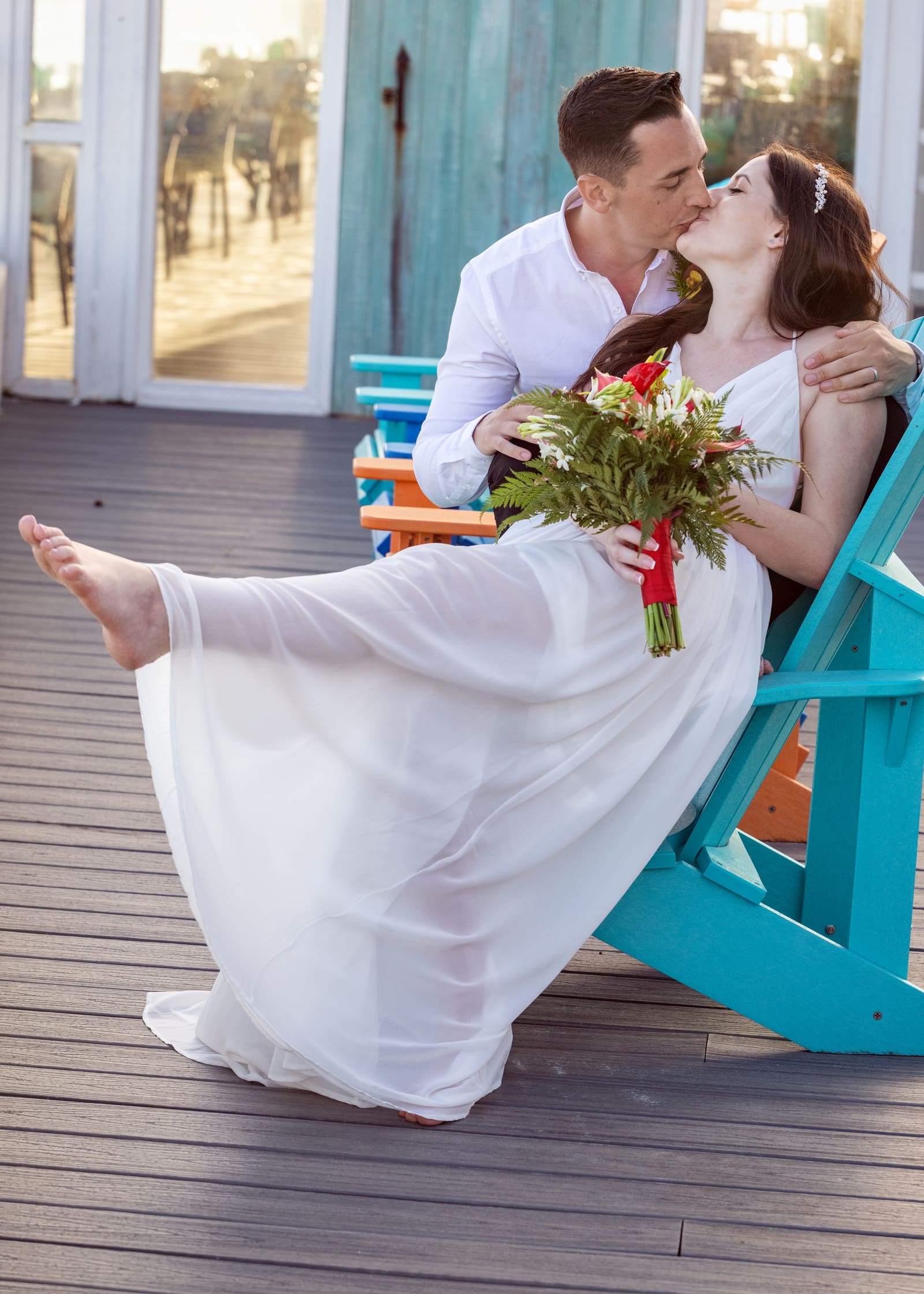 Groom lifting the bride on a veranda, Barbados