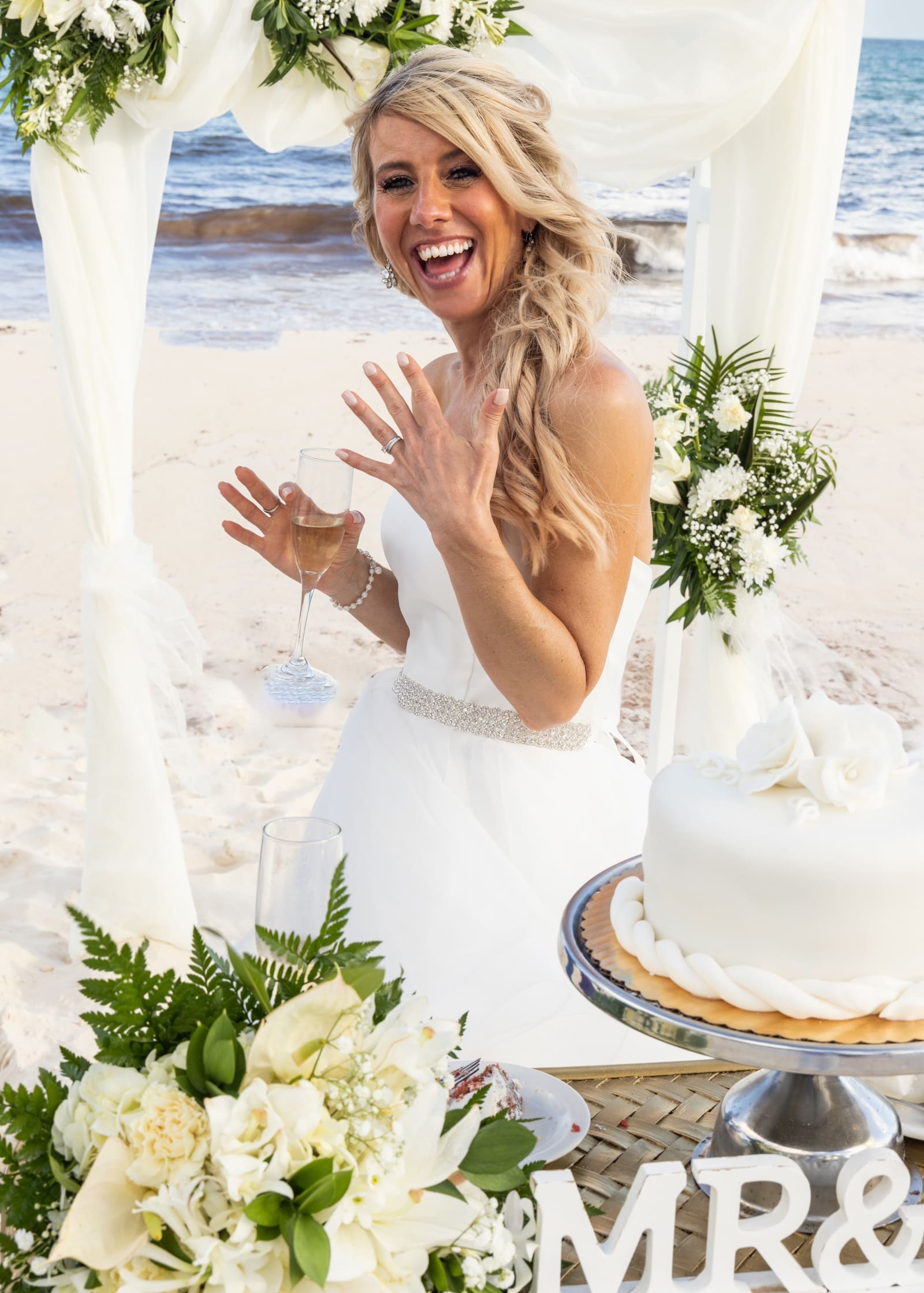Bride showing her ring beside the wedding cake, Barbados